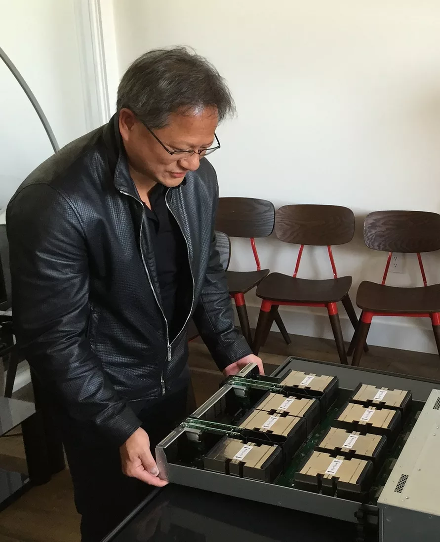 NVIDIA CEO opens the GPU tray on DGX-1 presented to OpenAI in San Francisco.